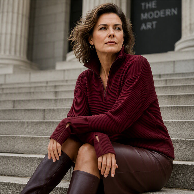 Close styling view of wine red ribbed quarter zip sweater